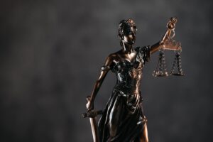 Bronze blindfolded Lady Justice statue holding scales and a sword, symbolizing legal rights before deciding should I talk to insurance adjuster