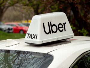 Uber taxi rooftop sign on a car, representing the rideshare vehicles involved when a rideshare accident occurs