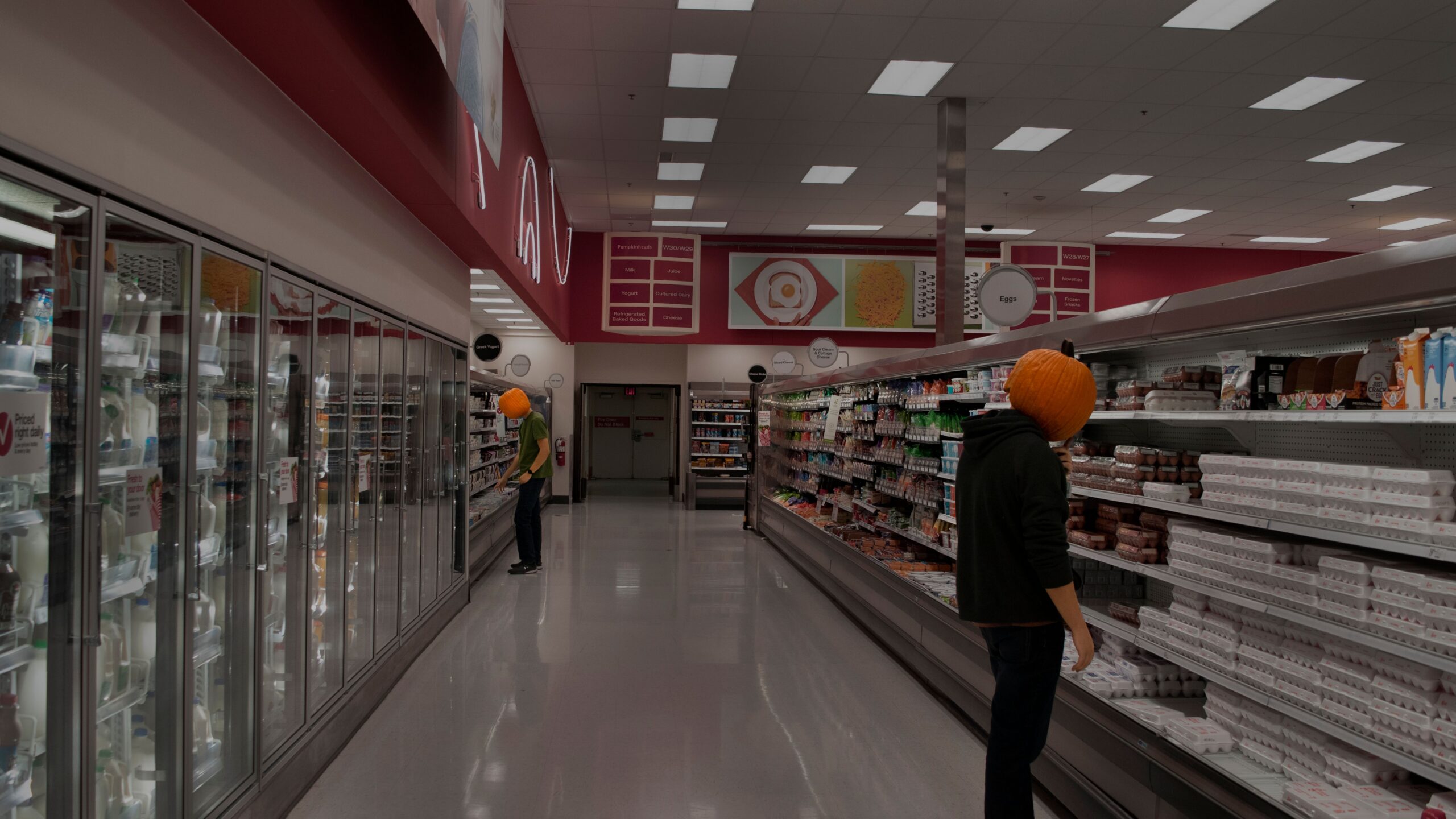 Wet, polished floor near open dairy cases in a grocery store aisle, a common spot for a slip and fall at a grocery store