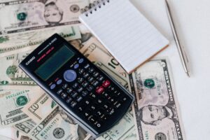 Hands exchanging cash near a gavel, representing hidden costs in a truck accident lawsuit clients should know about